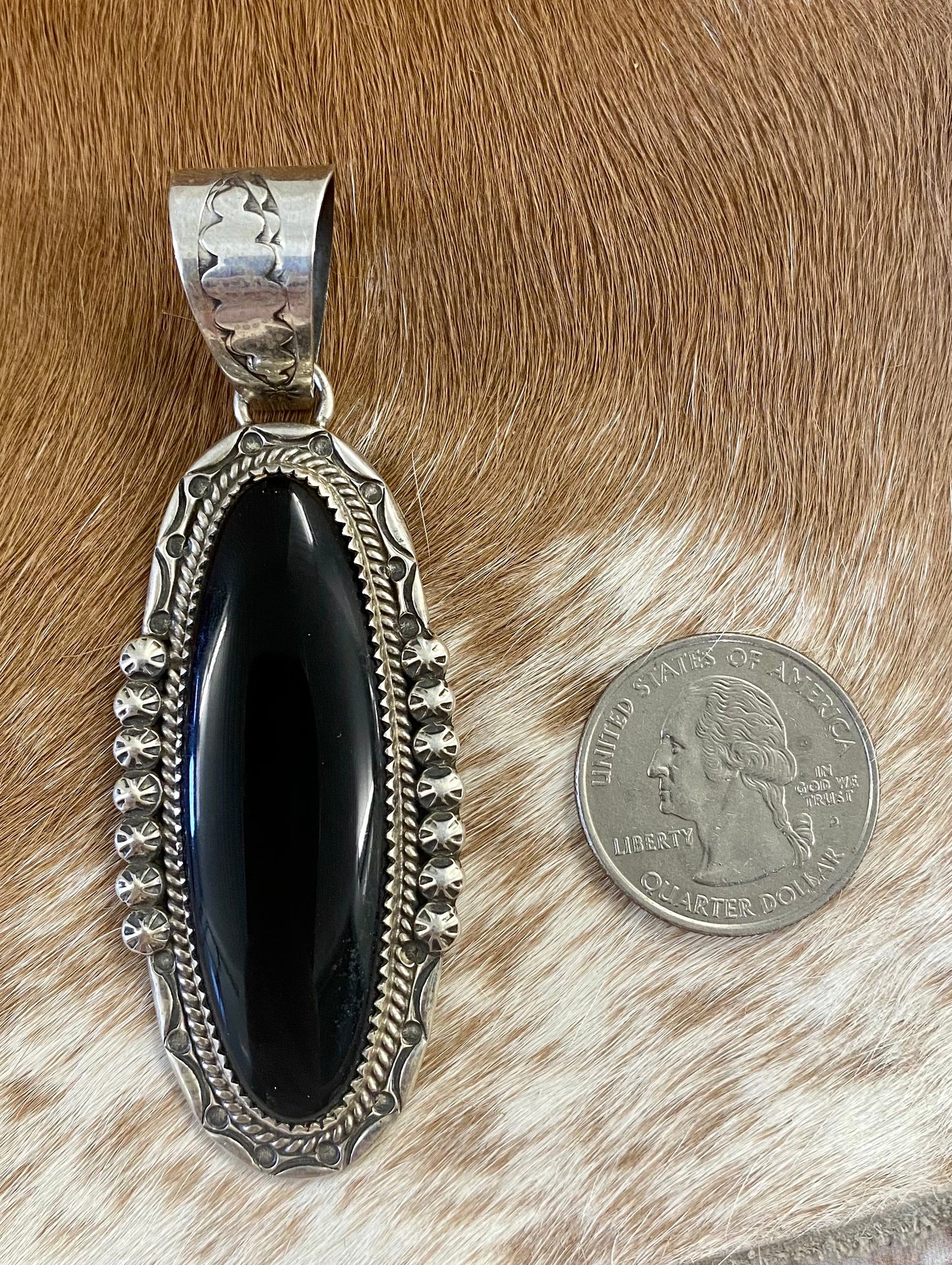 The perfect single stone sterling silver Native American made large onyx pendant to add to any necklace. This piece will look especially gorgeous on a strand of Navajo pearls. Stamped sterling and signed PY by Native artist silversmith Phillip Yazzie.    Size: 2.5” inch length + bale .75” inch   Signed: YES "PY"   Hallmark/ Artist: Phillip Yazzie  Stone: Onyx Large Black Onyx Pendant Handmade By Native American Phillip Yazzie