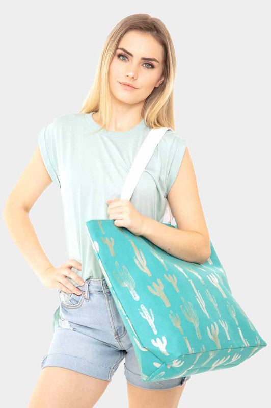 The perfect beach and farmers market bag featuring silver cacti across it. This turquoise tote bag has magnetic closure and one inside slip pocket. This also would make for a wonderful overnight bag. Size: 20.25" x 5" x 15.5"Material: 60% Cotton, 40% Polyester Cactus Tote Bag, Summer Cactus Beach Bag, Western Tote Bag