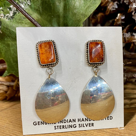 Stamped sterling orange spiny oyster post earrings with reflective mirror bottom. These spiny oyster Native American made earrings are stunning. They will make for an awesome statement piece in anyone's jewelry collection. Size: 2" Inch Length Stone: Spiny Oyster