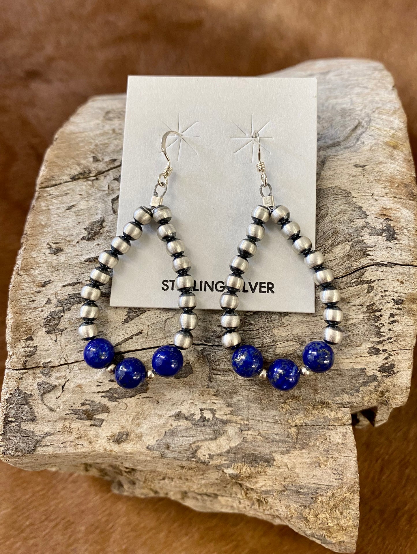 Gorgeous lightweight hand-strung Navajo pearl teardrop sterling silver lightweight earrings with three pieces of blue lapis stones at the bottom of each teardrop earring. The perfect earrings to add a pop of blue to any outfit!  Size: 1.5” inches length x 1” inch width   Stone: Blue Lapis & Navajo Pearl