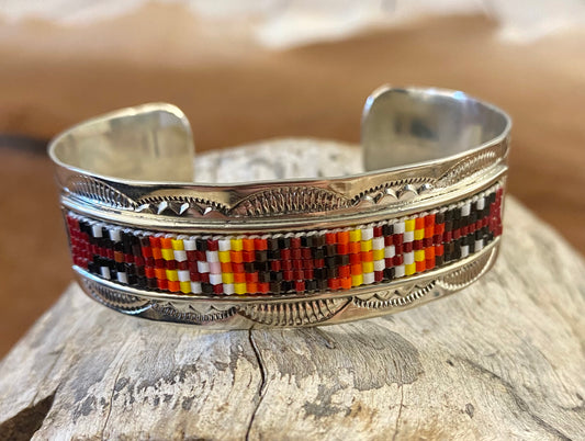 The Turnpike Aztec Beaded Cuff Beautiful unique stamped Nickle sliver and signed by Native American artist silversmith inside of the cuff band. Aztec seed beaded bright colorful Nickle silver cuff bracelet.   Size: 5” inches inside measurement - gap 1-1.5” inches 