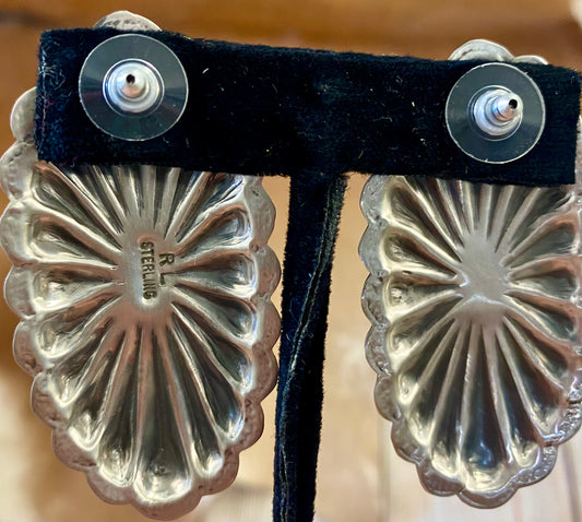 Beautiful large statement Concho sterling silver spiny oyster earrings with single stone pieces of in the center. Stamped sterling and signed by Native American artist silversmith Rita Lee. The perfect set of earrings to add in to anyone's jewelry collection. Dress them up or down!   Size: 2 1/2" Inches Long x  1 1/4" Inches Wide  Hallmark/Artist: Rita Lee  Stone: Spiny Oyster Sterling Silver Statement Concho Spiny Oyster Earrings By Rita Lee