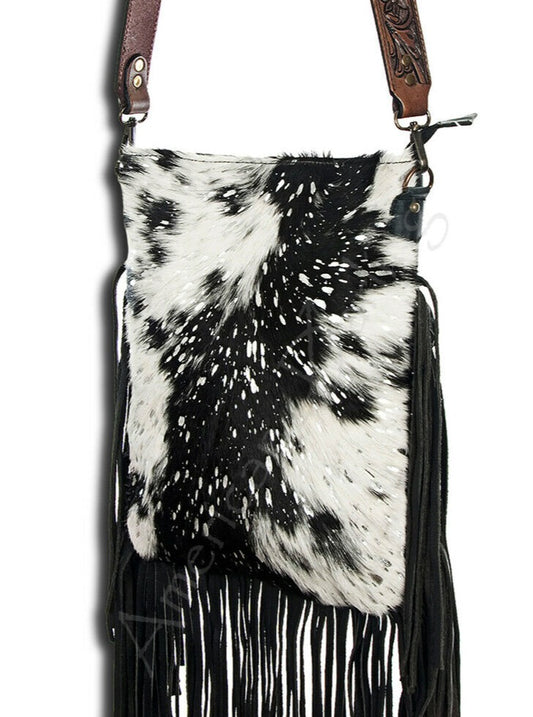Large Black and White American Darling Western Crossbody Fringe Purse If you like cowhide and fringe and you're looking for a really cute crossbody purse that is also concealed carry, we've got just the purse for you!  The Alex crossbody fringe purse is accented with silver metallic spots across the black and white hair on hide cowhide. It also has a removable tooled leather shoulder strap. It features 2 open pockets and 1 zipped pocket inside.